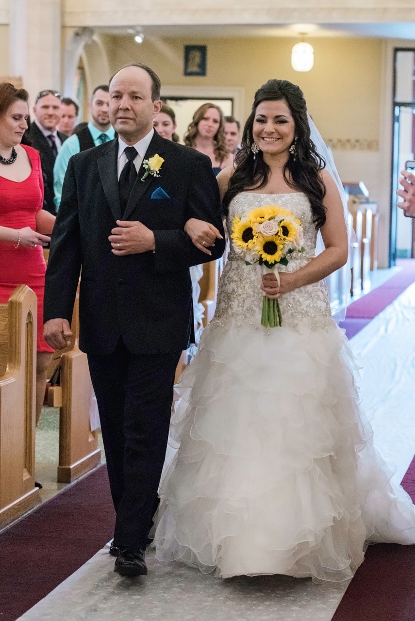 A bride and her father walk down the aisle